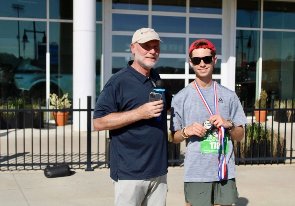 Participant holding medal — 2026 Strides for Autism