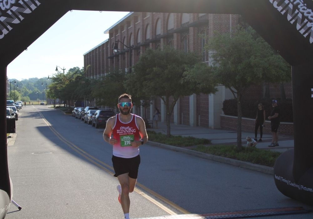 Runner crossing the finish line — 2026 Strides for Autism