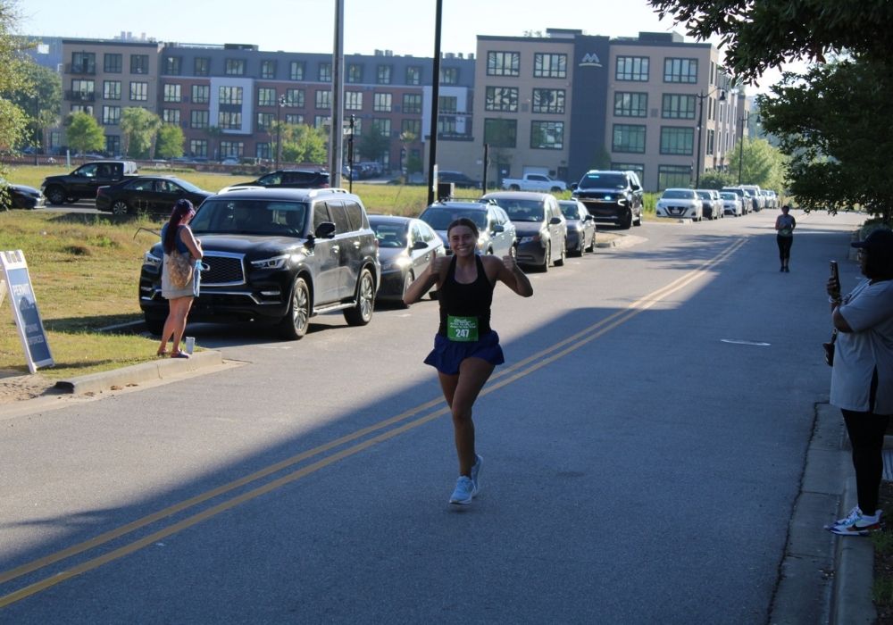 Runner giving thumbs up — 2026 Strides for Autism