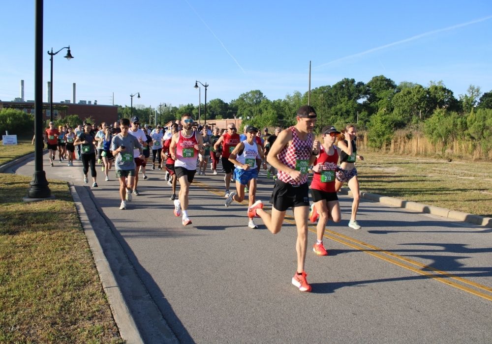 Runner group in morning sunlight — 2026 Strides for Autism