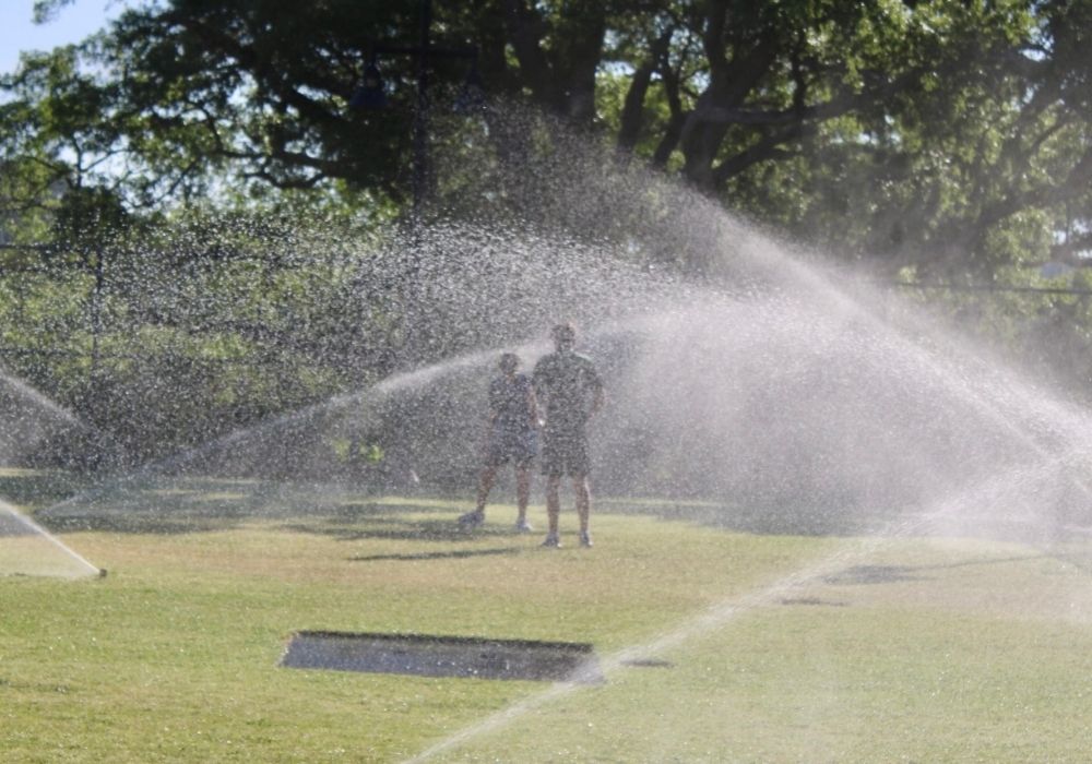 Runners in sprinklers — 2026 Strides for Autism