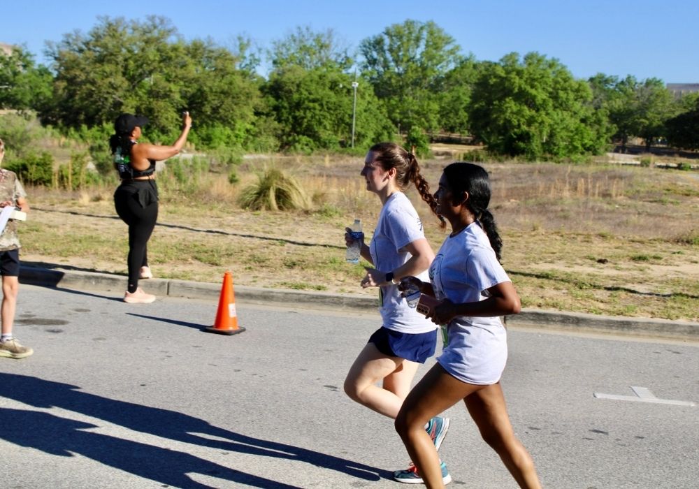 Runners side by side pacing — 2026 Strides for Autism