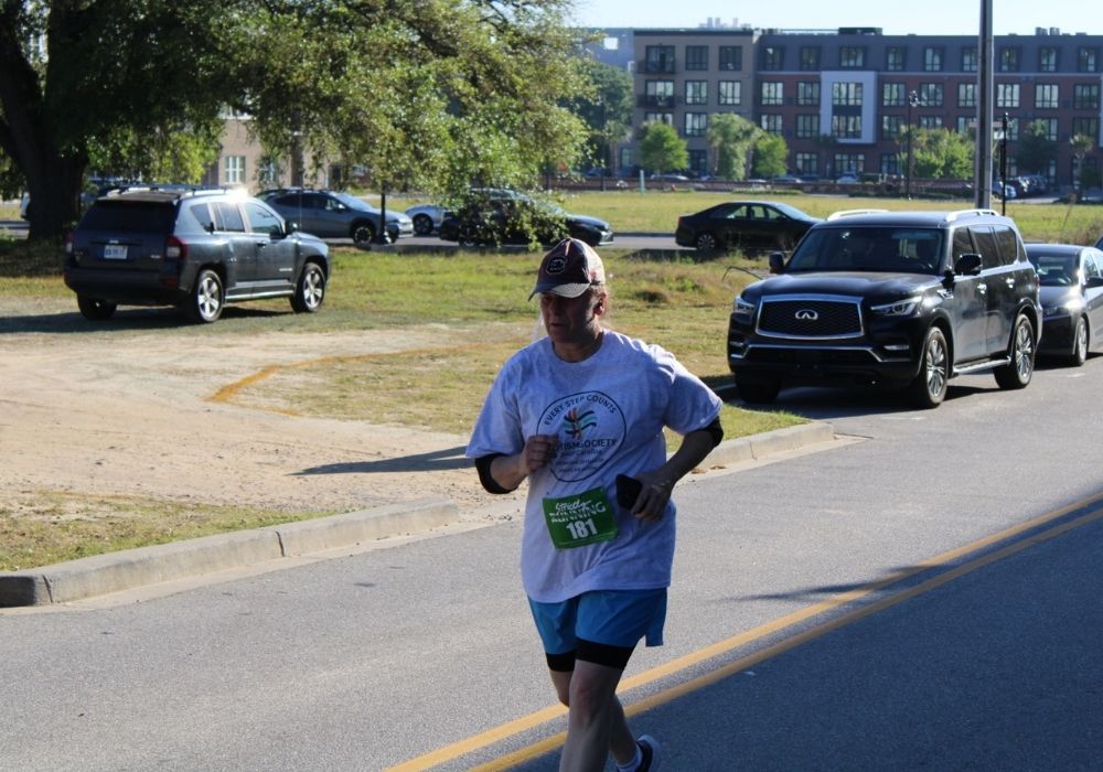 Solo runner mid stride — 2026 Strides for Autism