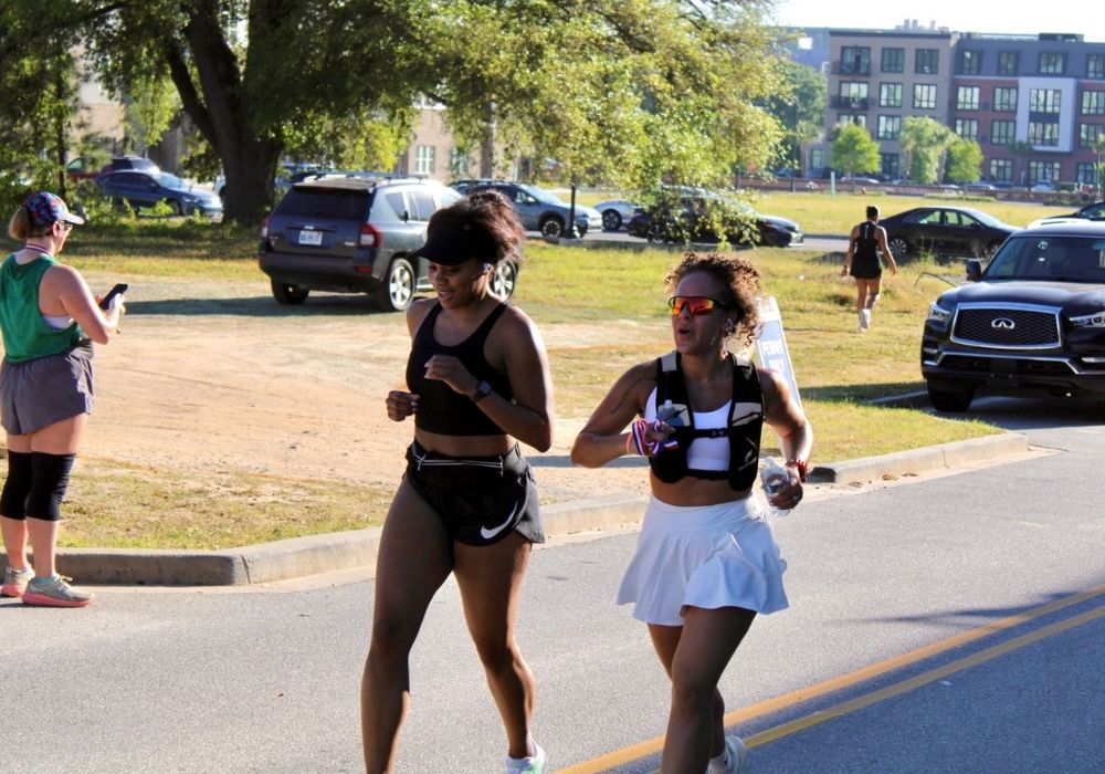 Woman runners side by side pacing — 2026 Strides for Autism