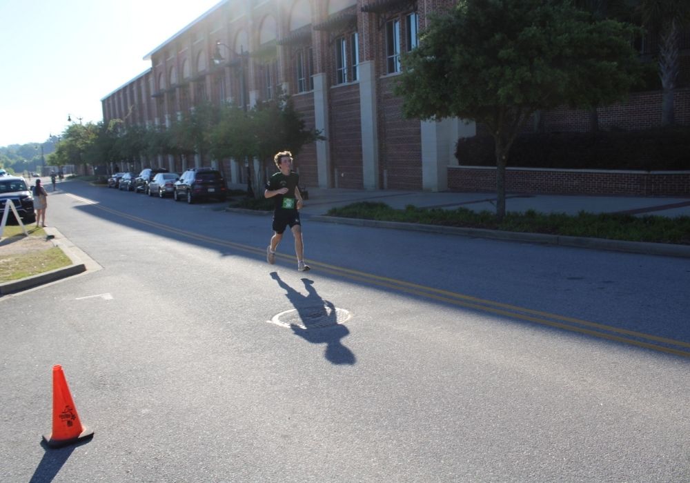Young runner finishing strong — 2026 Strides for Autism