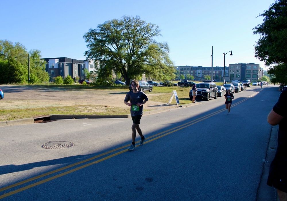 Young runner with race number — 2026 Strides for Autism